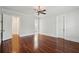 Bright bedroom featuring hardwood floors, a ceiling fan, and multiple doorways enhancing flow and accessibility at 2449 Daniel Island Dr, Daniel Island, SC 29492