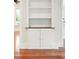 Built-in shelving and cabinet storage with hardwood floors, custom trim, and a neutral color palette at 2449 Daniel Island Dr, Daniel Island, SC 29492