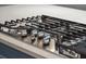 Close up of the kitchen island's cooktop, featuring stainless steel accents and precise temperature controls at 2449 Daniel Island Dr, Daniel Island, SC 29492