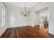 Dining room featuring hardwood floors, wainscoting, modern chandelier, and views into the kitchen at 2449 Daniel Island Dr, Daniel Island, SC 29492