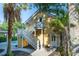 Exterior view of yellow home with white stairs leading up to an entrance, poolside at 2449 Daniel Island Dr, Daniel Island, SC 29492