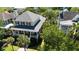 Aerial view of yellow two-story home with palm trees and well-maintained landscaping at 2449 Daniel Island Dr, Daniel Island, SC 29492