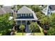 Charming two-story yellow home with lush landscaping and a welcoming front porch at 2449 Daniel Island Dr, Daniel Island, SC 29492