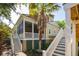 Home exterior with painted steps, palm trees and view of the neighbor's house at 2449 Daniel Island Dr, Daniel Island, SC 29492