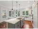 Beautiful kitchen with white cabinets, stainless steel appliances, an island cooktop, and a cozy window seat at 2449 Daniel Island Dr, Daniel Island, SC 29492