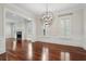 Living room with hardwood floors, wainscoting, fireplace, and modern chandelier at 2449 Daniel Island Dr, Daniel Island, SC 29492