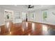 Bright living room featuring hardwood floors, recessed lighting, and large windows overlooking tropical outdoor scenery at 2449 Daniel Island Dr, Daniel Island, SC 29492