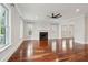 Spacious living room with hardwood floors, fireplace, and lots of natural light from the windows at 2449 Daniel Island Dr, Daniel Island, SC 29492