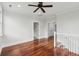 Spacious loft featuring hardwood floors, neutral walls, and a view of an adjacent hallway and doors at 2449 Daniel Island Dr, Daniel Island, SC 29492