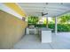 Covered outdoor kitchen features stainless steel grill, granite countertop and prep space for cooking and entertaining at 2449 Daniel Island Dr, Daniel Island, SC 29492