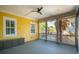 Bright screened porch features an overhead fan, built-in bench seating and views of palm trees at 2449 Daniel Island Dr, Daniel Island, SC 29492