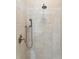 Detailed shot of a shower with neutral-toned tiles, multiple shower heads, and classic hardware at 2449 Daniel Island Dr, Daniel Island, SC 29492