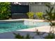 An eye-level view of a private swimming pool with clear blue water and a tile border, set against a backdrop of lush greenery at 2449 Daniel Island Dr, Daniel Island, SC 29492