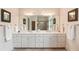 Elegant bathroom with double vanity, large mirror, and neutral color scheme at 26 Beachwood East, Isle of Palms, SC 29451