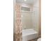 Bathroom featuring a shower/tub with a window and a shell-patterned shower curtain at 26 Beachwood East, Isle of Palms, SC 29451