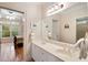 Bathroom featuring a double vanity, a large mirror, and decorative accents at 26 Beachwood East, Isle of Palms, SC 29451
