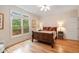 Bedroom with hardwood floors, window with a view, and wooden furniture at 26 Beachwood East, Isle of Palms, SC 29451