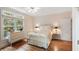 Bedroom featuring hardwood floors, a full size bed, and a large window with natural light at 26 Beachwood East, Isle of Palms, SC 29451