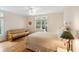 This spacious bedroom features hardwood floors, a ceiling fan, and a large window providing natural light at 26 Beachwood East, Isle of Palms, SC 29451