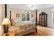 Traditional bedroom with a four-poster bed, hardwood floors, and bright natural light at 26 Beachwood East, Isle of Palms, SC 29451