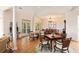 Bright dining area with hardwood floors, columns, modern lighting, and easy access to the outside patio at 26 Beachwood East, Isle of Palms, SC 29451
