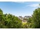 View of houses with blue skies in the background and trees in the foreground at 26 Beachwood East, Isle of Palms, SC 29451