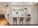 Bright kitchen with white cabinets, bar seating, open to the dining area, and hardwood floors at 26 Beachwood East, Isle of Palms, SC 29451
