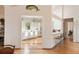 Bright kitchen with white cabinets, bar seating, and hardwood floors open to the dining area at 26 Beachwood East, Isle of Palms, SC 29451