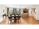 Open-concept living and dining area with hardwood floors and large windows at 26 Beachwood East, Isle of Palms, SC 29451