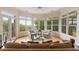 Bright living room featuring expansive windows, a ceiling fan, and comfortable seating for relaxing and enjoying the natural light at 26 Beachwood East, Isle of Palms, SC 29451