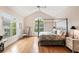 Bright bedroom with a four-poster bed and arched windows that let in ample light at 26 Beachwood East, Isle of Palms, SC 29451