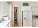 Pantry with full shelves and white cabinets in the kitchen at 26 Beachwood East, Isle of Palms, SC 29451