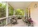 Inviting covered porch with plush seating and serene outdoor views at 26 Beachwood East, Isle of Palms, SC 29451