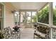 Charming screened porch with comfortable seating, perfect for relaxing at 26 Beachwood East, Isle of Palms, SC 29451