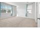 Bright, airy bedroom featuring light-colored carpet, neutral walls and two windows at 261 Celestial Blvd, Summerville, SC 29486
