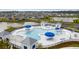 Beautiful community pool with blue umbrellas, lounge chairs, and pristine water, surrounded by well-manicured landscaping at 261 Celestial Blvd, Summerville, SC 29486