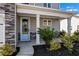 Close-up of a charming front porch with a light blue door and stone accents at 261 Celestial Blvd, Summerville, SC 29486