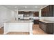 A kitchen with a large center island, granite countertops, stainless steel appliances, and dark wood cabinets at 261 Celestial Blvd, Summerville, SC 29486