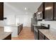 View of open concept kitchen with granite countertops and stainless steel appliances with a pantry and gas range stove at 261 Celestial Blvd, Summerville, SC 29486