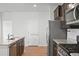 Open kitchen with granite countertops, pantry door, and stainless appliances at 261 Celestial Blvd, Summerville, SC 29486