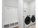 Functional mud room with bench seating, storage, and modern washer and dryer at 261 Celestial Blvd, Summerville, SC 29486