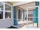 The home has a screened porch with decorative curtains and access to the backyard at 261 Celestial Blvd, Summerville, SC 29486