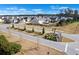 Street view of the landscaped community, featuring sidewalks and mature trees at 261 Celestial Blvd, Summerville, SC 29486