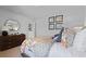 Bright bedroom with neutral walls, modern mirror and honeycomb pattern bedspread and pillows at 288 Watersglen Dr, Summerville, SC 29486