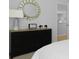 Bedroom decor with dark wood dresser, round mirror and a bright window at 288 Watersglen Dr, Summerville, SC 29486