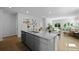 Open concept kitchen with a large island, stainless steel sink, and seating area at 288 Watersglen Dr, Summerville, SC 29486