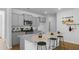 Bright kitchen with granite countertops and bar stool seating on the large kitchen island at 288 Watersglen Dr, Summerville, SC 29486