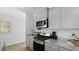 Well-lit kitchen featuring gray cabinets, granite countertops, and stainless steel appliances at 288 Watersglen Dr, Summerville, SC 29486
