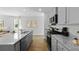 Stylish kitchen featuring gray cabinets, granite countertops, and stainless steel appliances, perfect for cooking and entertaining at 288 Watersglen Dr, Summerville, SC 29486