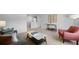 Bright living room with neutral walls and carpeting, including a gray sofa and a salmon colored arm chair at 288 Watersglen Dr, Summerville, SC 29486